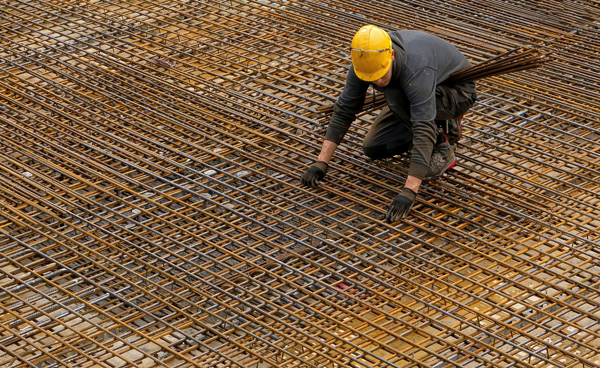 worker laying metal rods